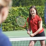 Young girls playing tennis